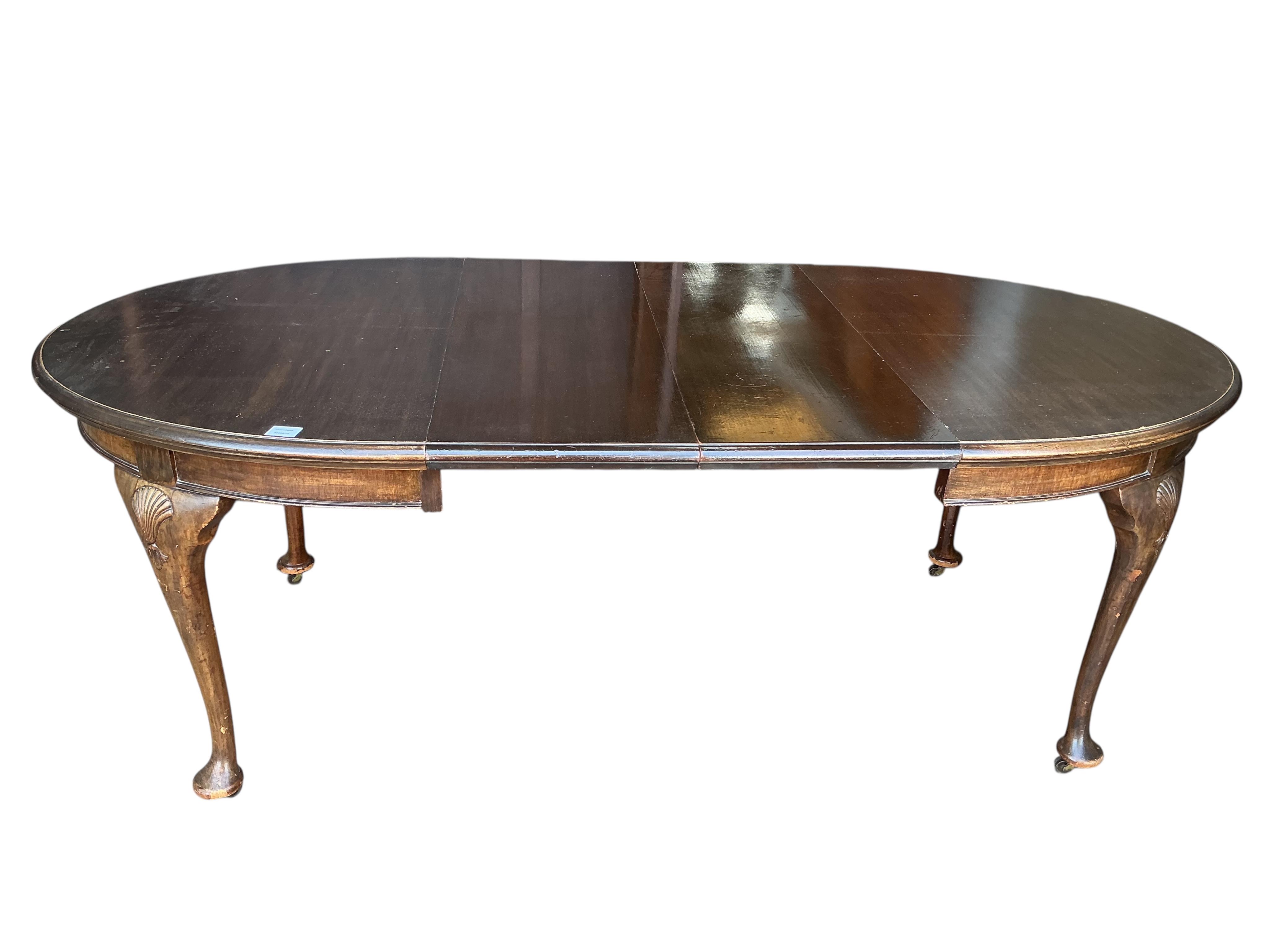 A Chippendale Revival mahogany extending dining table, 210cm extended, two spare leaves, depth 106cm, height 74cm together with a set of six Chippendale Revival mahogany dining chairs, two with arms